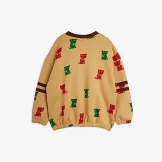 Beige sweatshirt featuring a red and green Kittens print and brown striped sleeves.