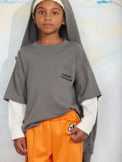 Grey long-sleeve top featuring layered sleeves, a chest pocket with Field Notes embroidery, worn by a child.