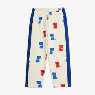 Off-white sweatpants featuring red and blue Kittens print, blue side panels and drawstring waist.