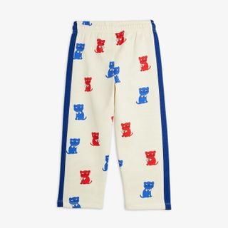 Off-white sweatpants featuring a red and blue Kittens print and blue contrast side panels.