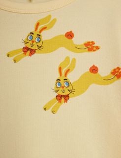 Close-up of the yellow Rabbits print featuring jumping rabbits wearing orange bow ties.