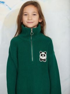Green chunky knit half-zip sweater featuring a panda patch on the chest, worn by a child.
