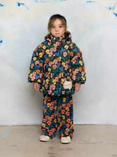 Child wearing matching Violas print hooded jacket and velour trousers.