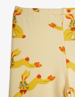 Close-up of yellow leggings featuring an elastic waistband and an illustrated Rabbits print.