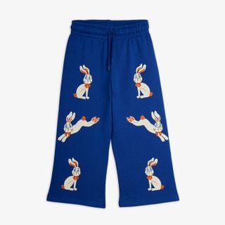 Blue wide-leg sweatpants featuring white rabbits with orange bows and an elastic drawstring waist.