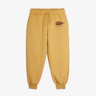 Beige organic cotton sweatpants featuring Elephant Shrew embroidery, a drawstring waistband, and elastic cuffs.