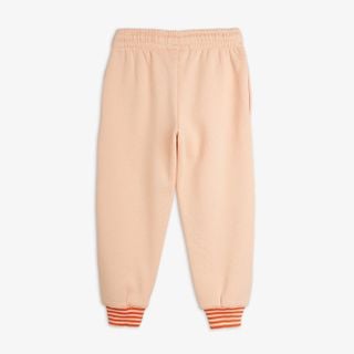 Pink sweatpants with an elasticated waist and orange striped ribbed cuffs, viewed from the back.