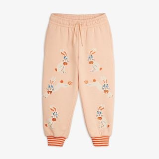 Pink sweatpants featuring a Rabbit print, drawstring waist, and orange striped leg cuffs.