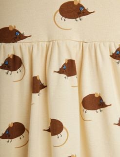 Close-up of beige dress with brown Elephant Shrew print and gathered waist detailing.