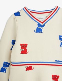 Off-white sweatdress with red and blue Kittens print and striped V-neck and waistband.
