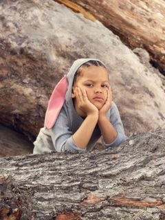 Grey fine knit dress with a hooded rabbit ear detail, worn by a child outdoors.