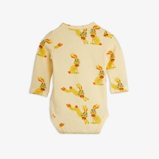 Yellow long-sleeved bodysuit featuring a repeating Rabbits print with yellow rabbits wearing red bows.