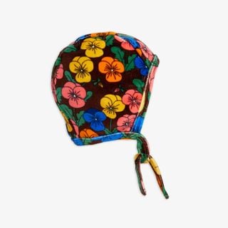 Dark brown velour baby helmet featuring a colorful Violas flower print and tie-strings.