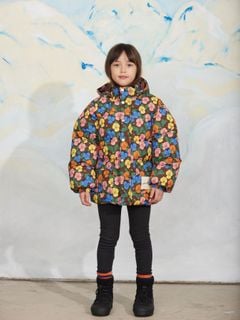 Brown heavy puffer jacket featuring a colorful viola print and front pockets, worn by a child.
