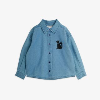 Blue denim shirt featuring a black Skunk motif on the chest, a classic collar, and button closure.