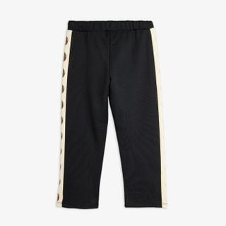 Black organic cotton sweatpants with cream Elephant shrew side panels, back view.