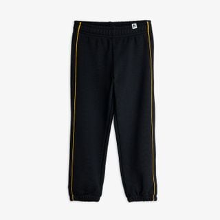 Black sweatpants featuring yellow piping details along the legs, shown from the front.