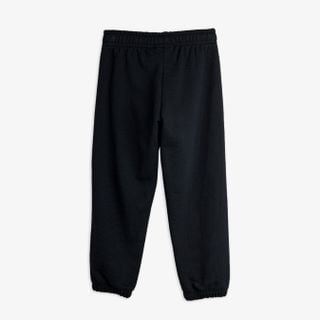 Black sweatpants shown from the back, featuring an elastic waistband and cuffs.