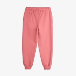 Pink sweatpants featuring an elastic drawstring waist and ribbed cuffs.
