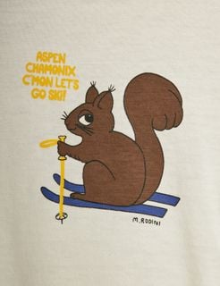 Close-up of a brown squirrel print on fabric with blue skis and yellow text saying Aspen Chamonix C'mon let's go ski!