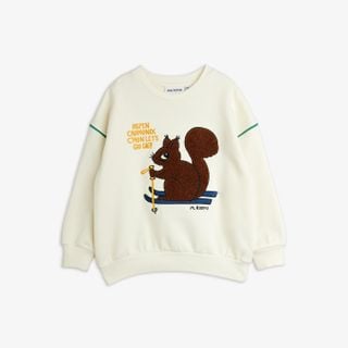 Off-white crew neck sweatshirt featuring a brown Skiing Squirrel chenille patch and green piping details.