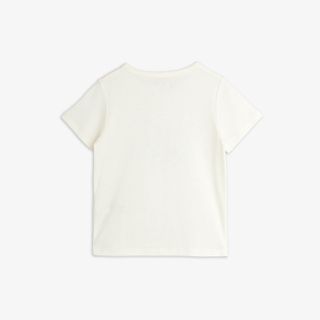Off-white short-sleeved top seen from the back.