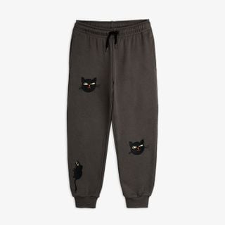 Grey sweatpants featuring embroidered cat and rat motifs and a drawstring waistband.