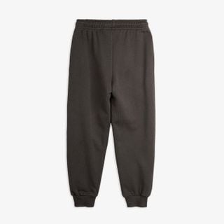 Grey sweatpants featuring an elastic waistband and ribbed cuffs, shown from the back.
