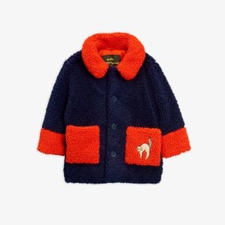 Blue faux fur jacket with contrasting red collar, cuffs, and front pockets, featuring an embroidered cat on the pocket.