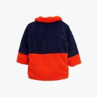 Blue and orange faux fur jacket viewed from the back with a high collar.