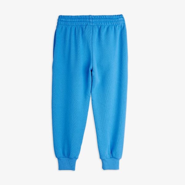 Blue sweatpants featuring an elastic waistband and ribbed cuffs, shown from the back.