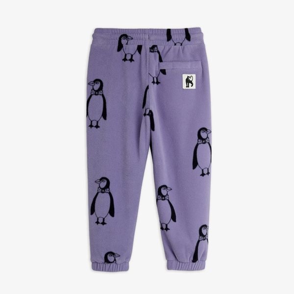 Purple fleece trousers with a penguin print and a back pocket featuring a panther label, shown from the back.
