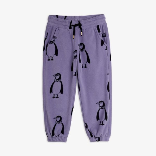 Purple trousers with an all-over penguin print, drawstring waist, side pockets, and elastic cuffs.