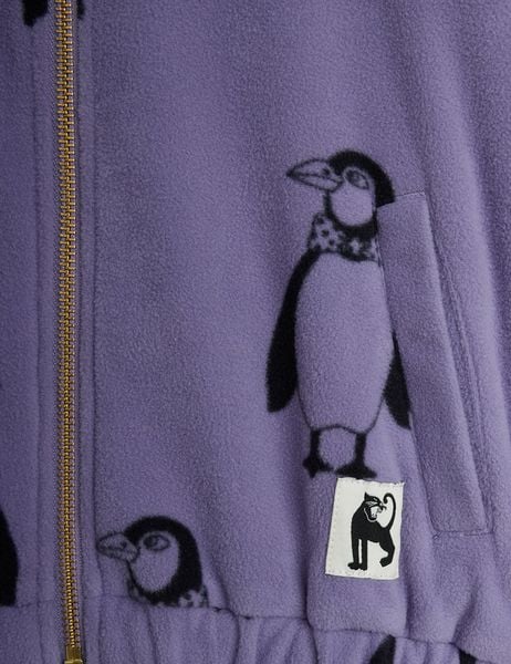 Close-up of a purple fleece jacket with a Penguin print, a gold-toned zipper, and a black panther logo patch.