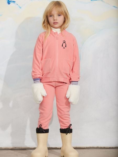 Pink zip-up jacket with a penguin embroidery on the chest and front pockets, worn by a child.