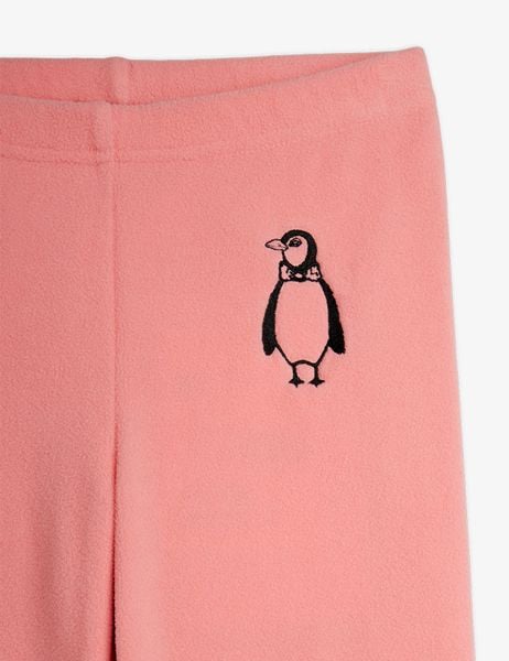 Close-up of pink microfleece trousers featuring a detailed penguin embroidery with a bow tie.