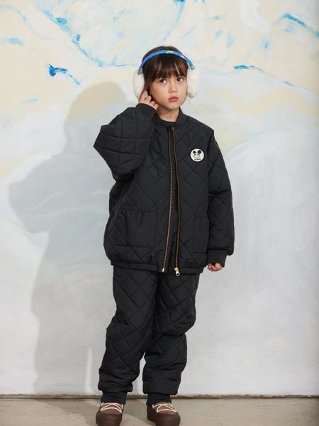 Black quilted outerwear jacket and matching trousers featuring a Ritzratz patch.