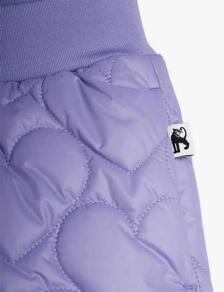 Close-up of purple quilted trousers featuring a heart pattern, ribbed waistband, and a black panther logo tag.