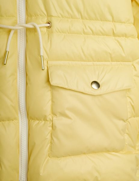 Yellow puffer jacket detail showing a white zipper, pocket with a gold snap button, and white drawstring.
