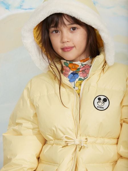 Yellow heavy puffer jacket with a Ritzratz patch and a faux fur-lined hood.