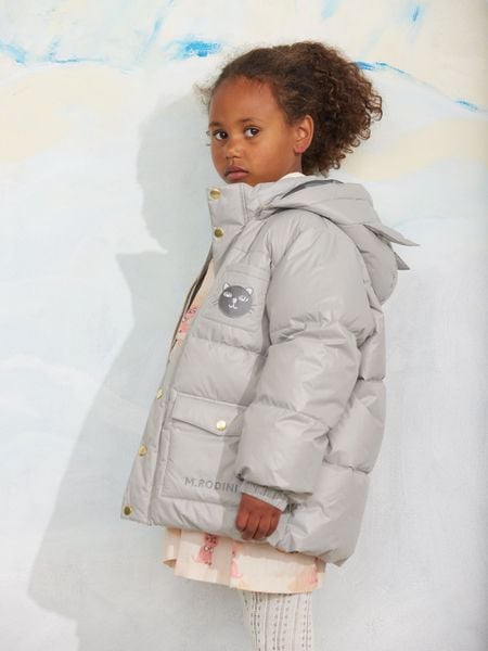 Grey heavy puffer jacket featuring a hood with cat ears, a cat patch on the chest, and front pockets.