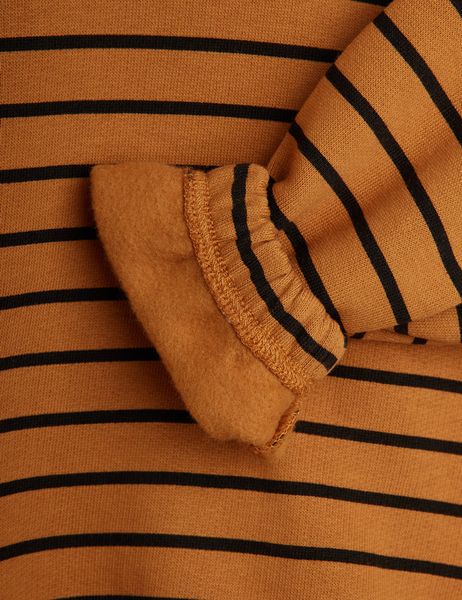 Close-up of a brown and black striped sweatshirt showing the soft brushed interior and ribbed cuff.