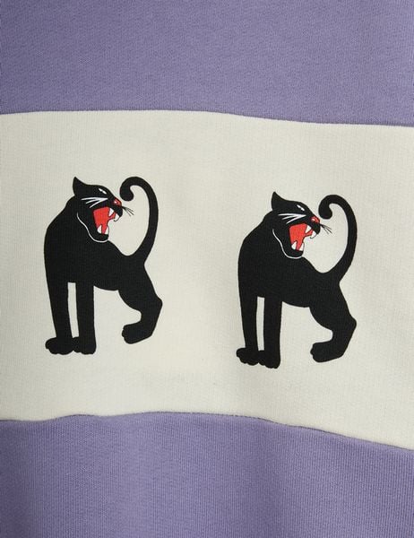 Close-up of a white contrast chest panel featuring two black panther motifs with red mouths on a purple sweatshirt.
