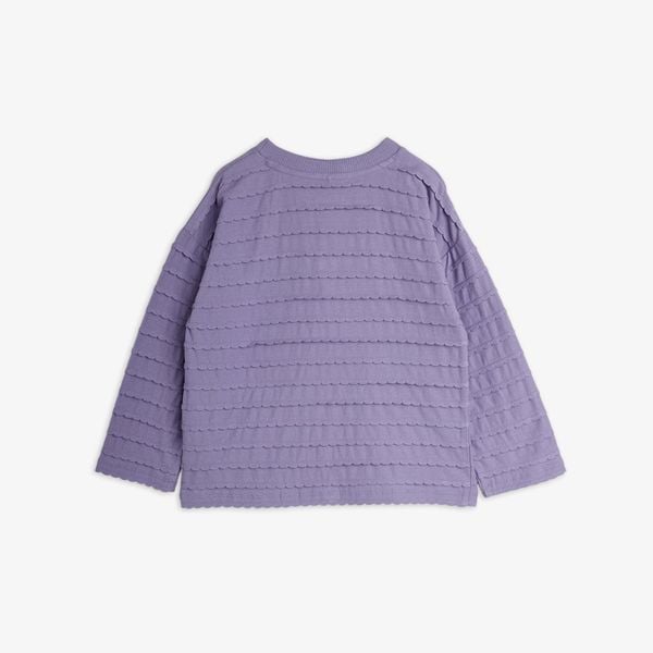 Purple long-sleeved blouse with horizontal textured frill rows and a ribbed rounded neckline, shown from the back.