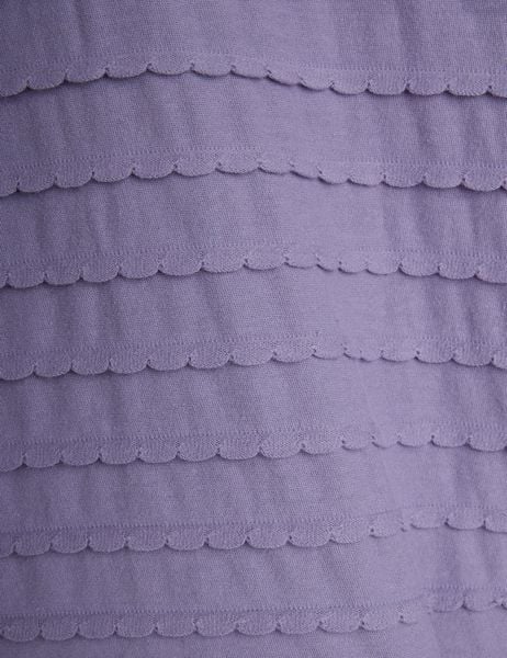 Close-up of purple fabric featuring horizontal rows of textured scalloped frills.