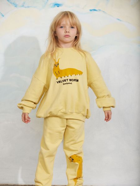 Yellow sweat set featuring a Velvet worm print and ribbed trims, worn by a child.