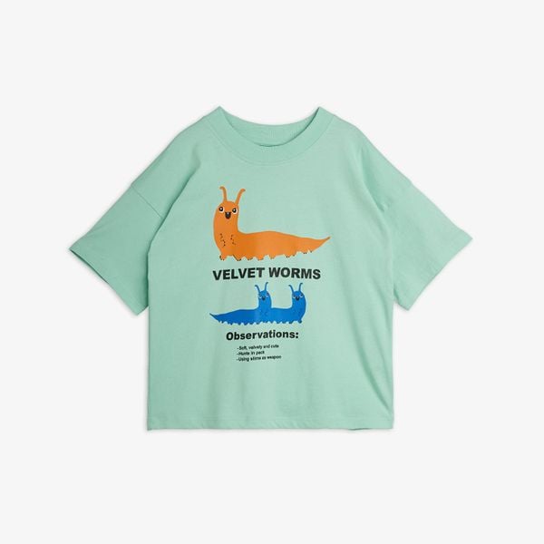 Green T-shirt featuring a Velvet worm print with text, dropped shoulders, and a ribbed neckline.