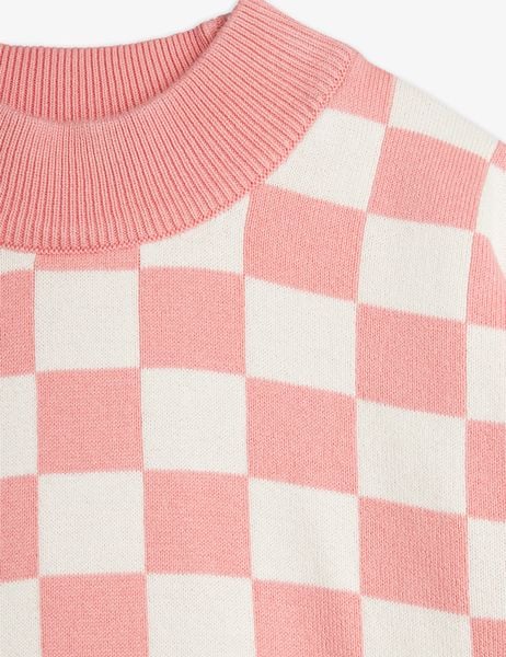 Close-up of a pink and white checkered knitted sweater with a ribbed neckline.