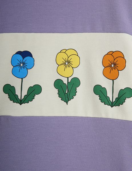 Close-up of a panel featuring blue, yellow, and orange flowers on a purple top.