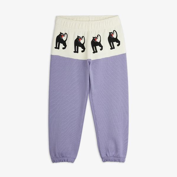 Purple sweatpants featuring an off-white front panel with black Panther prints and ribbed cuffs.